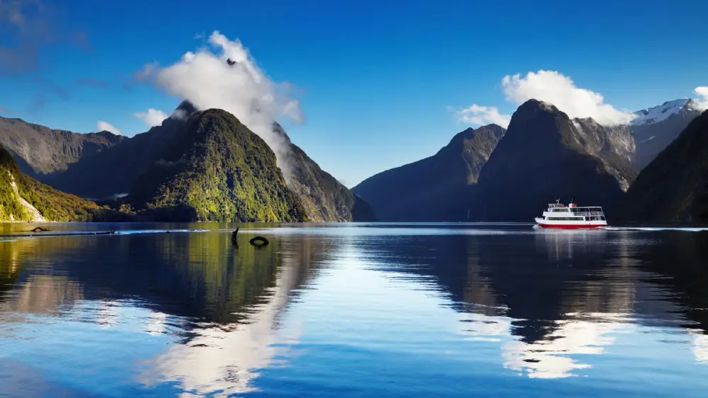 Boat cruising through Milford Sound