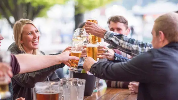 Group of friends cheers their beers together