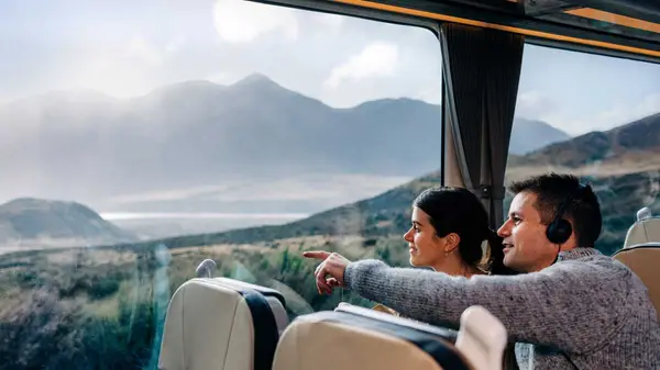 Couple look at view from Tranz Alpine train