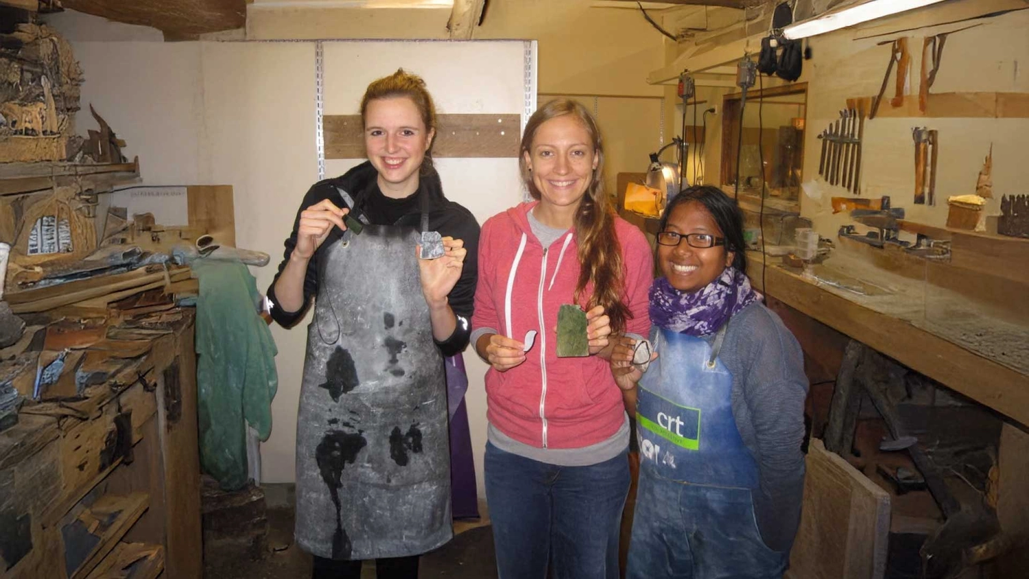 Group of people hold up their jade carvings