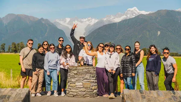 Group of people pose for a photo in Haast Pass