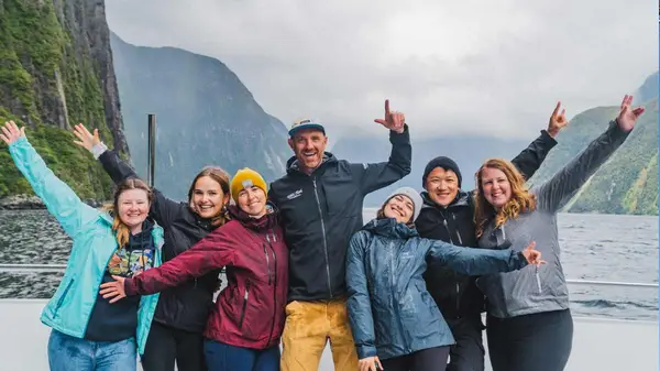 Group of people pose for a photo on a Milford Sound cruise