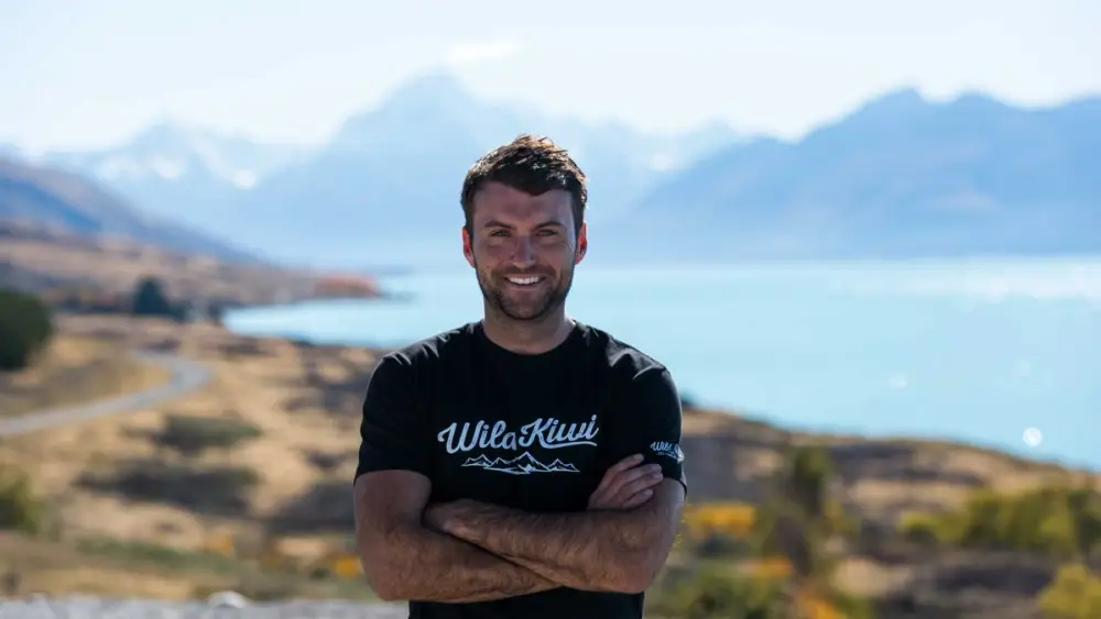 Wild Kiwi guide posing for a photo in front of Lake Pukaki