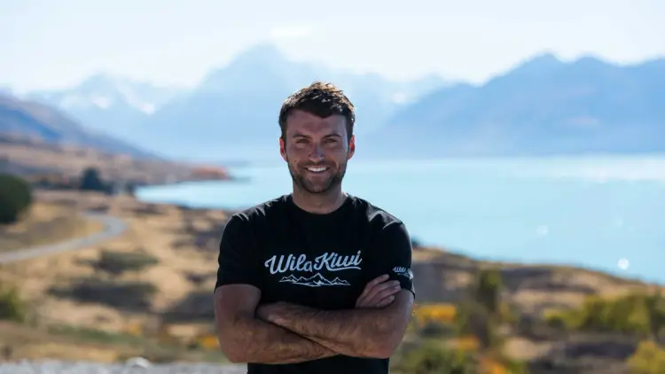 Wild Kiwi guide posing for a photo in front of Lake Pukaki