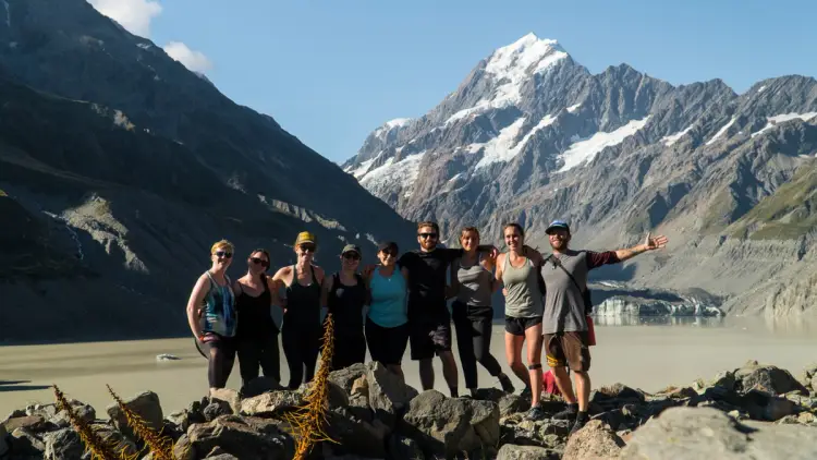 Group of people pose for a photo at Mount Cook