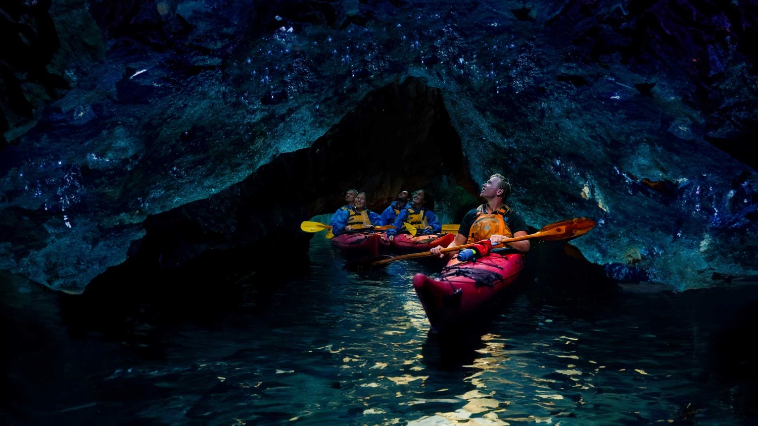 Group of kayakers in a glowworm cave