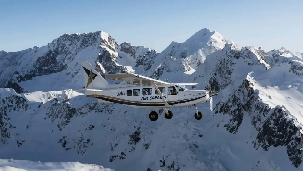 Small plane flying across the Southern Alps