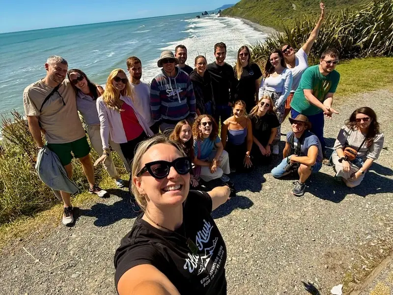 Group selfie from a Wild Kiwi guide with lots of smiling and happy travellers on a small group tour.