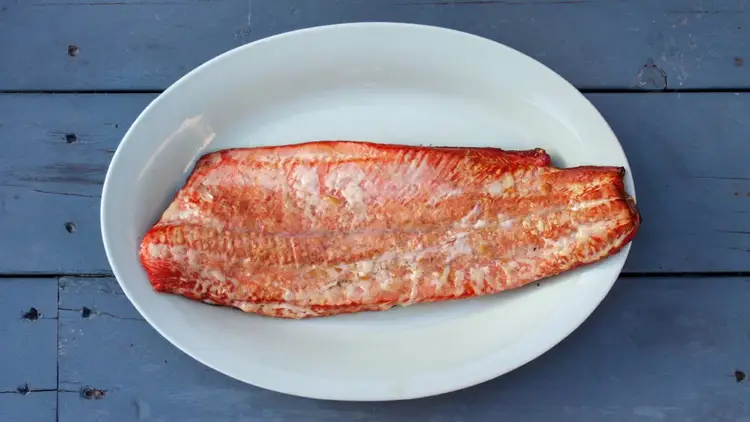 Plate with some smoked fish on it