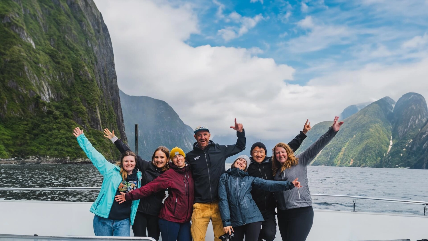 Photo of a group of people on a tour through Milford Sound in New Zealand.