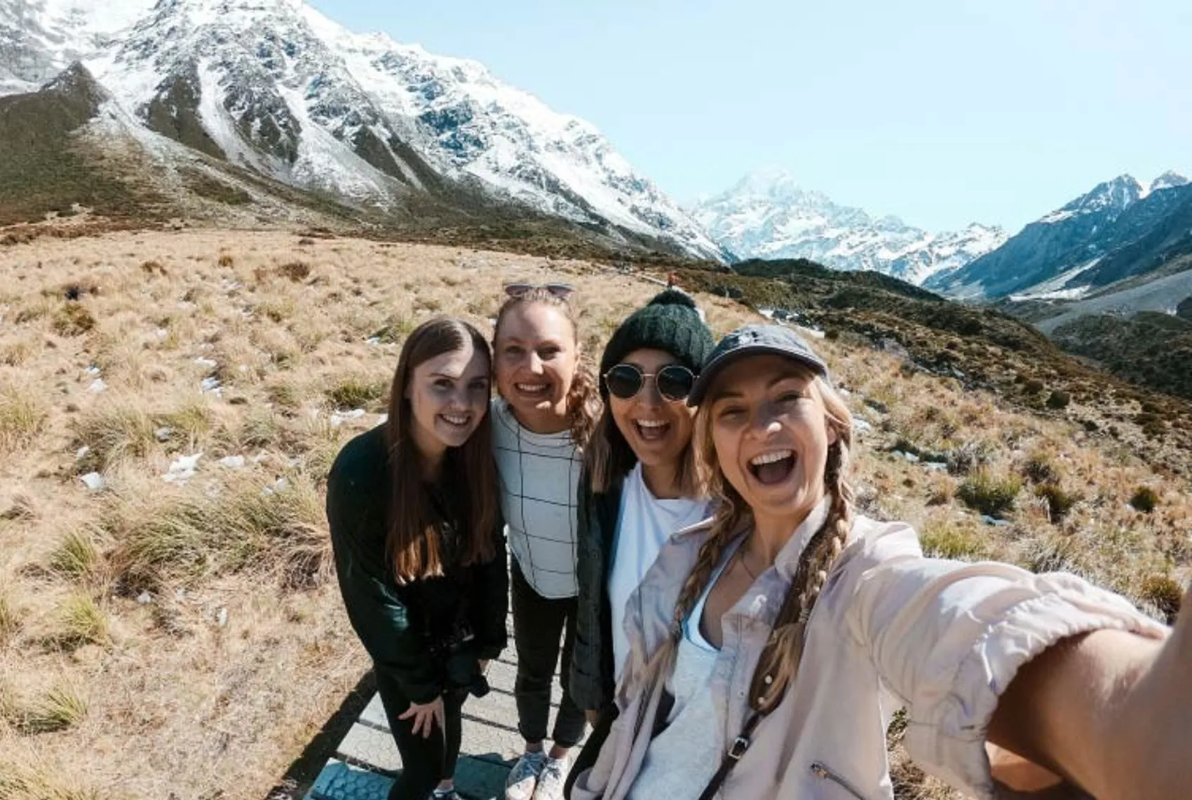 Group of women take a selfie in front of some mountains in New Zealand