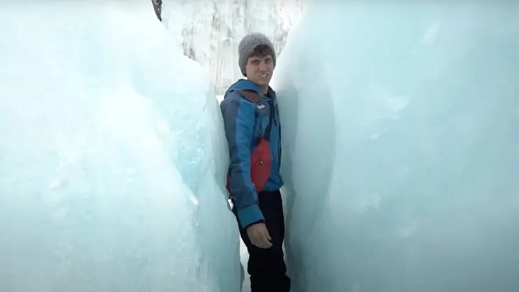 Man squeezing between the ice on Franz Josef Glacier