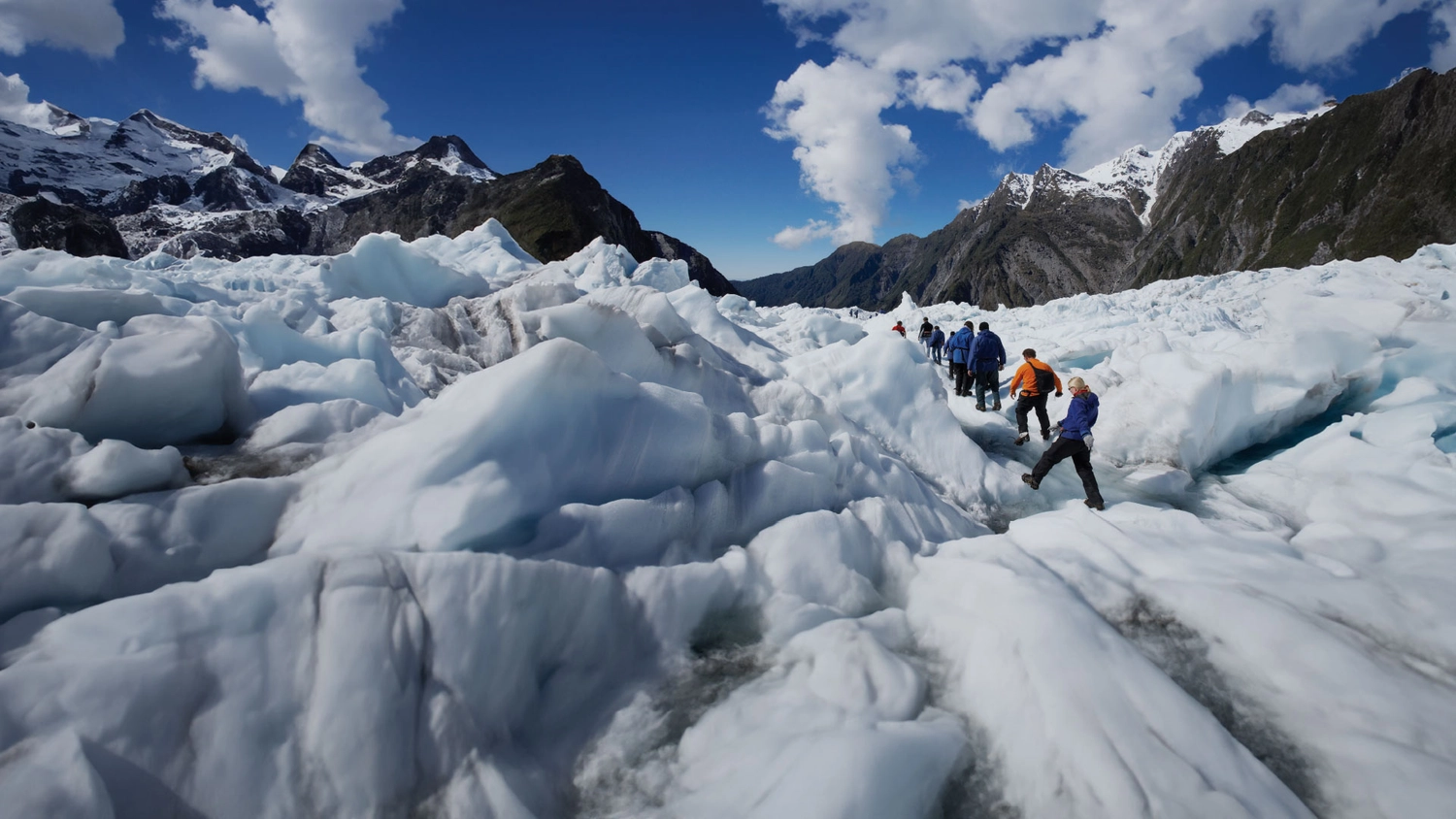 Group of people hiking up Franz Josef Glacier in New Zealand