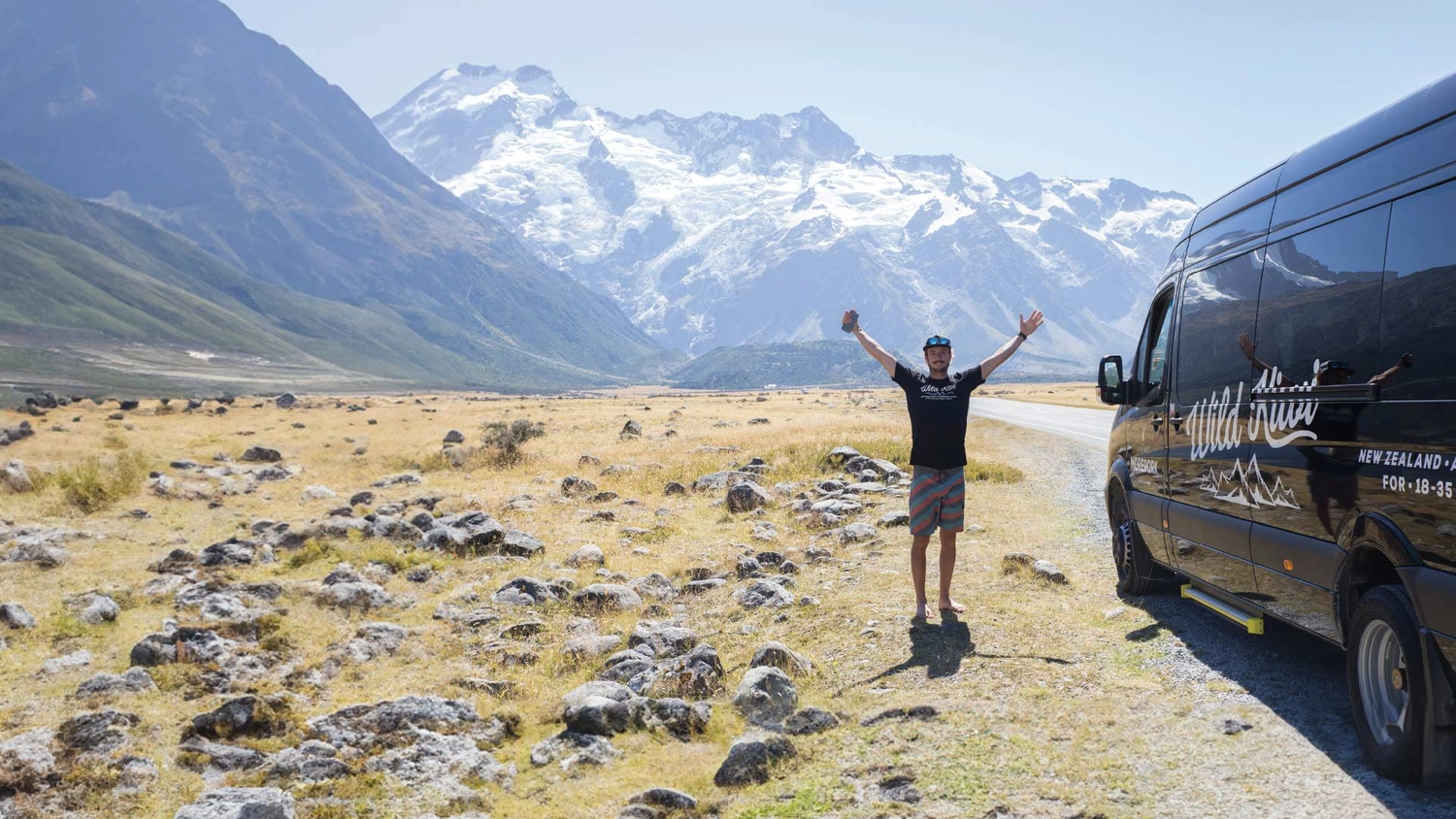 Wild Kiwi guide standing in front of some mountains in New Zealand