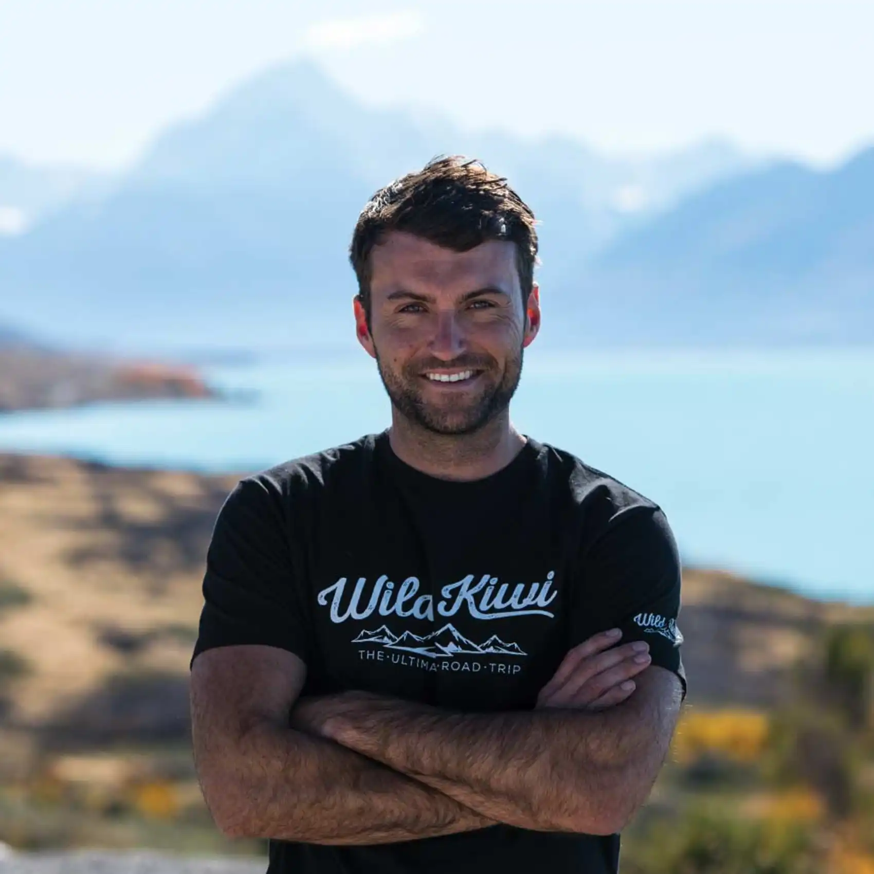 Wild Kiwi guide standing in front of Lake Tekapo