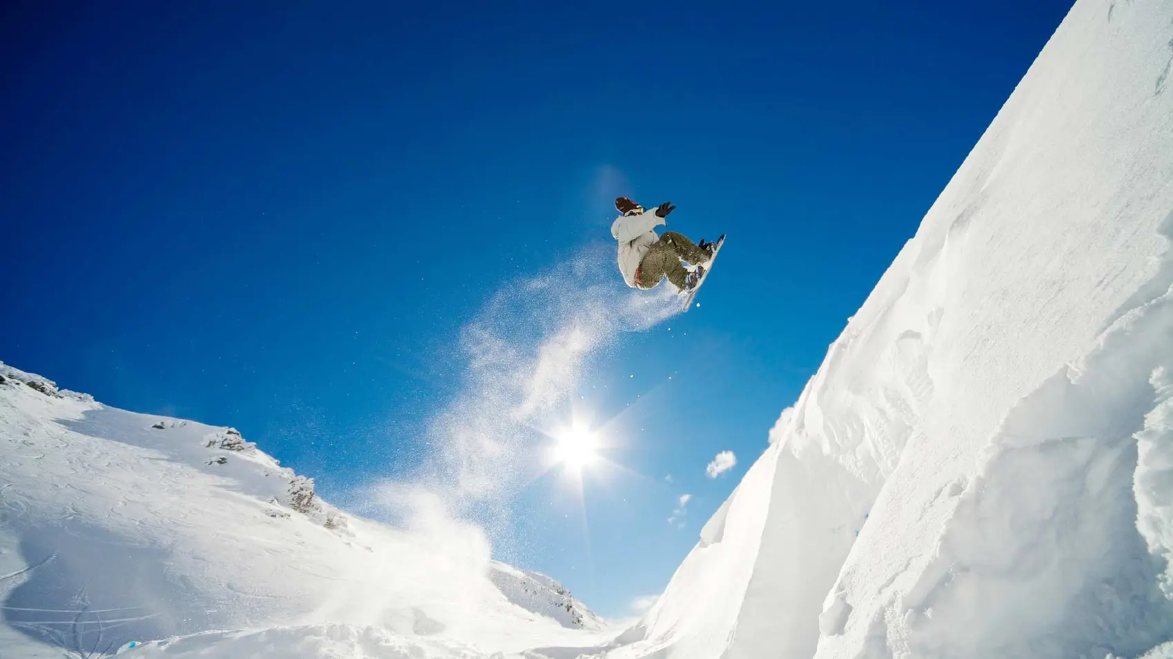 Person doing a jump on a snowboard