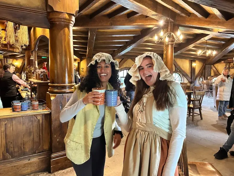 Two new travel friends stand in the Green Dragon Inn in Hobbiton New Zealand