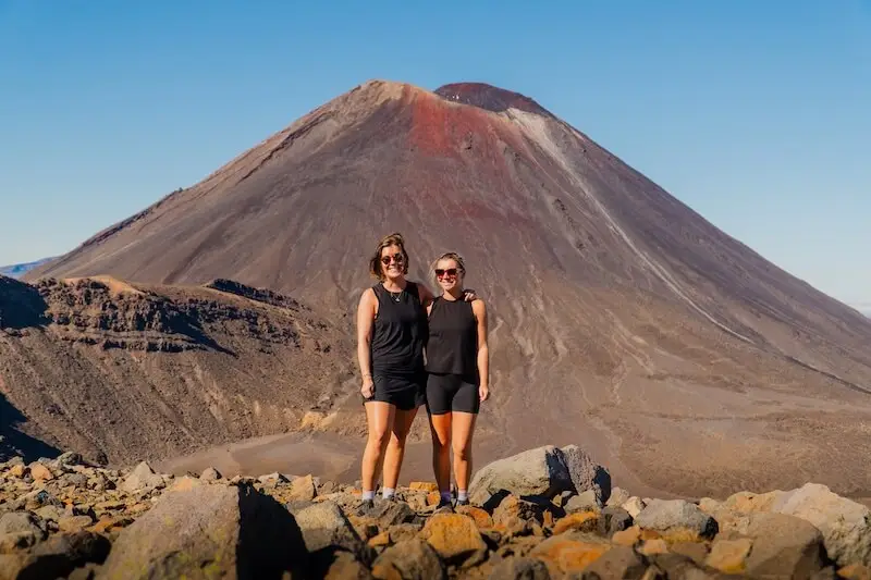 Photo of two females on the Tongariro Crossing in summer as an activity on a New Zealand road trip with Wild Kiwi. One of the best summer activities in New Zealand.