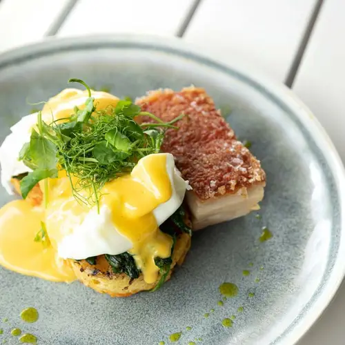 Eggs benedict with pork belly