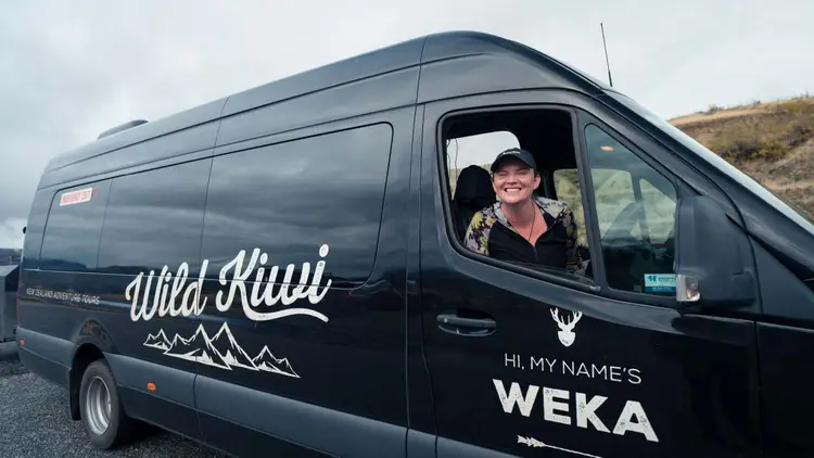 Wild Kiwi guide sitting in drivers seat of vehicle