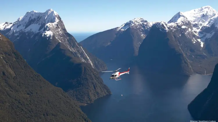 Helicopter flying over Milford Sound