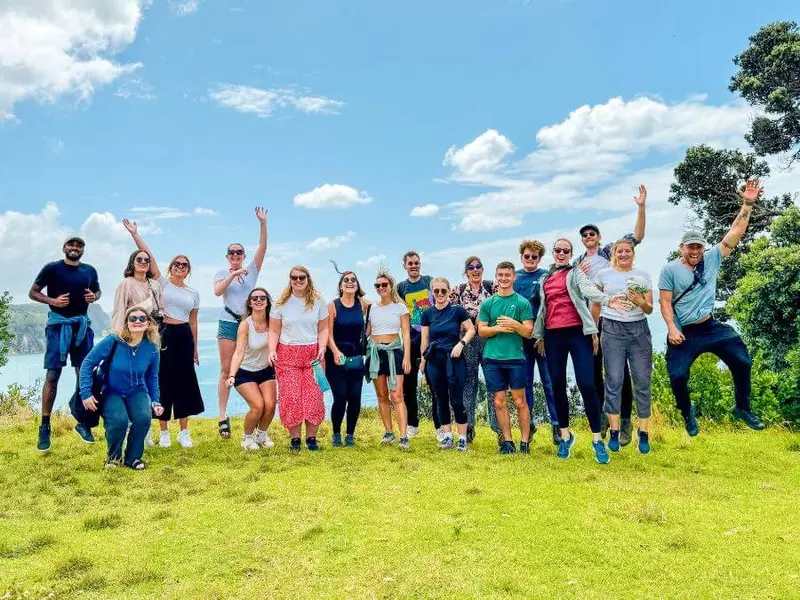 A group of happy travellers in their 20s and 30s on an adventure tour around New Zealand with Wild Kiwi.