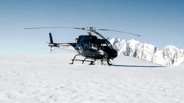 Helicopter and plane on a glacier in New Zealand