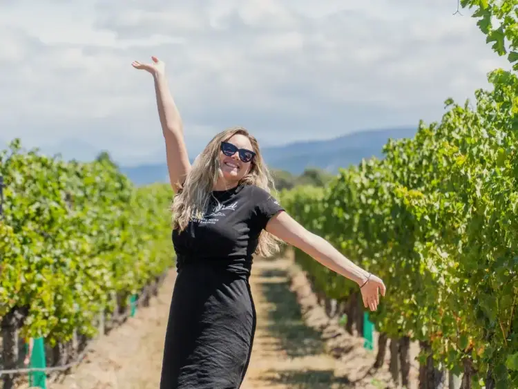 Woman amongst some vines in Marlborough
