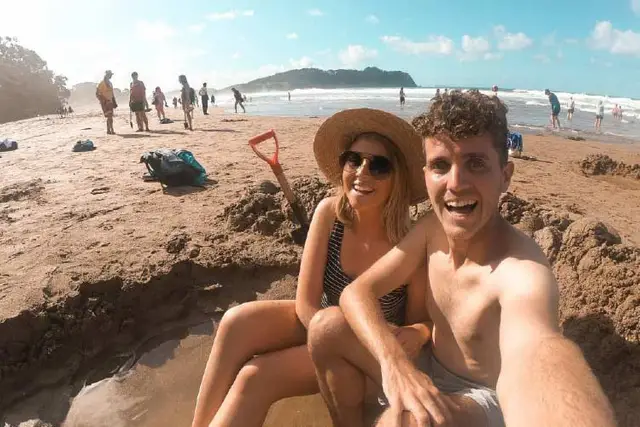 Couple in a warm water pool on Hot Water Beach