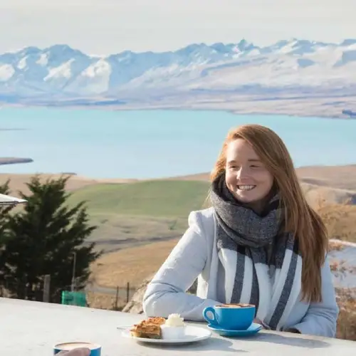 Woman enjoying a cake with a view at Astro Cafe