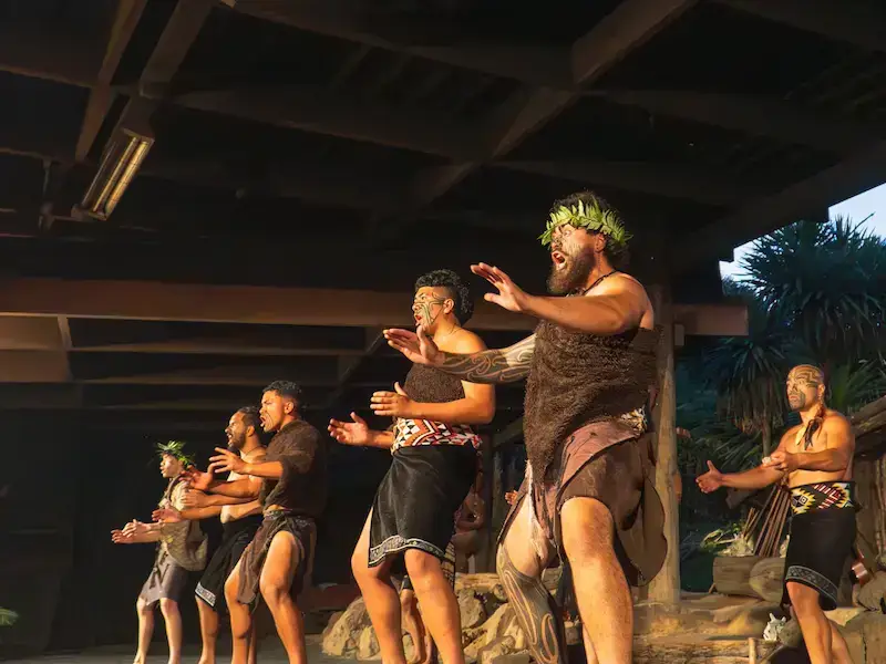 Māori cultural performance with traditional haka and dance in Rotorua, New Zealand, showcasing indigenous heritage and customs.