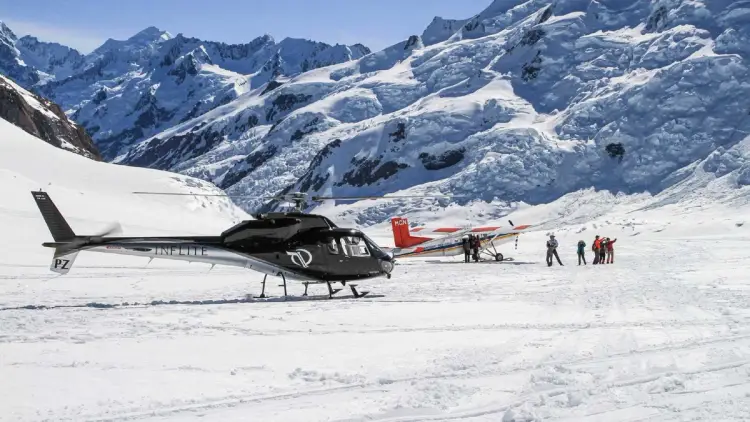 Helicopter and plane on a glacier in New Zealand