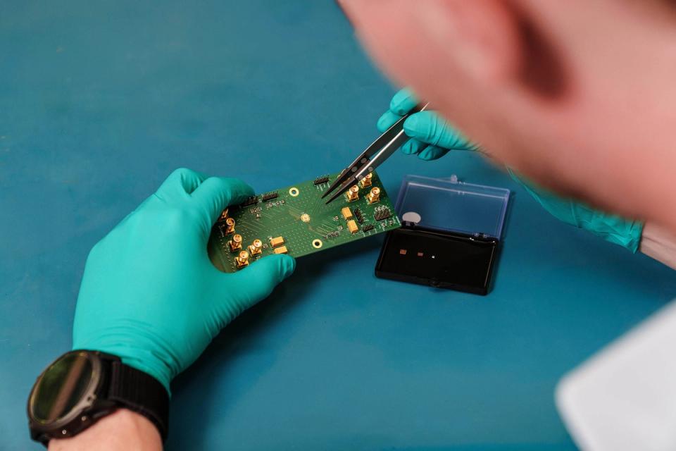 A cryoCMOS IC being placed into a testing PCB board.