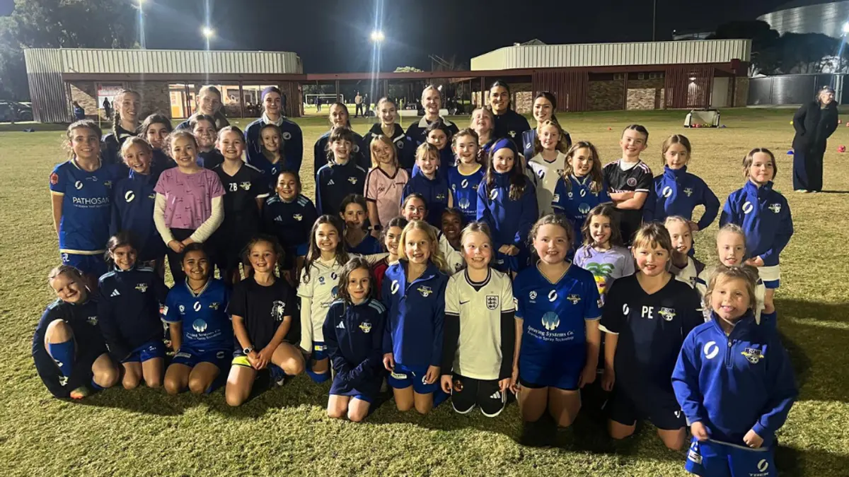 group photo of senior women players and junior girls