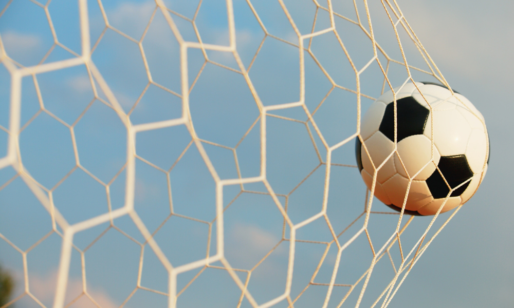 photo of ball in soccer goal