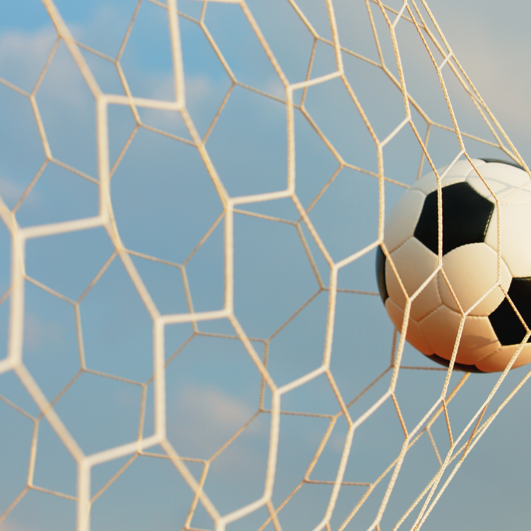 photo of ball in soccer goal