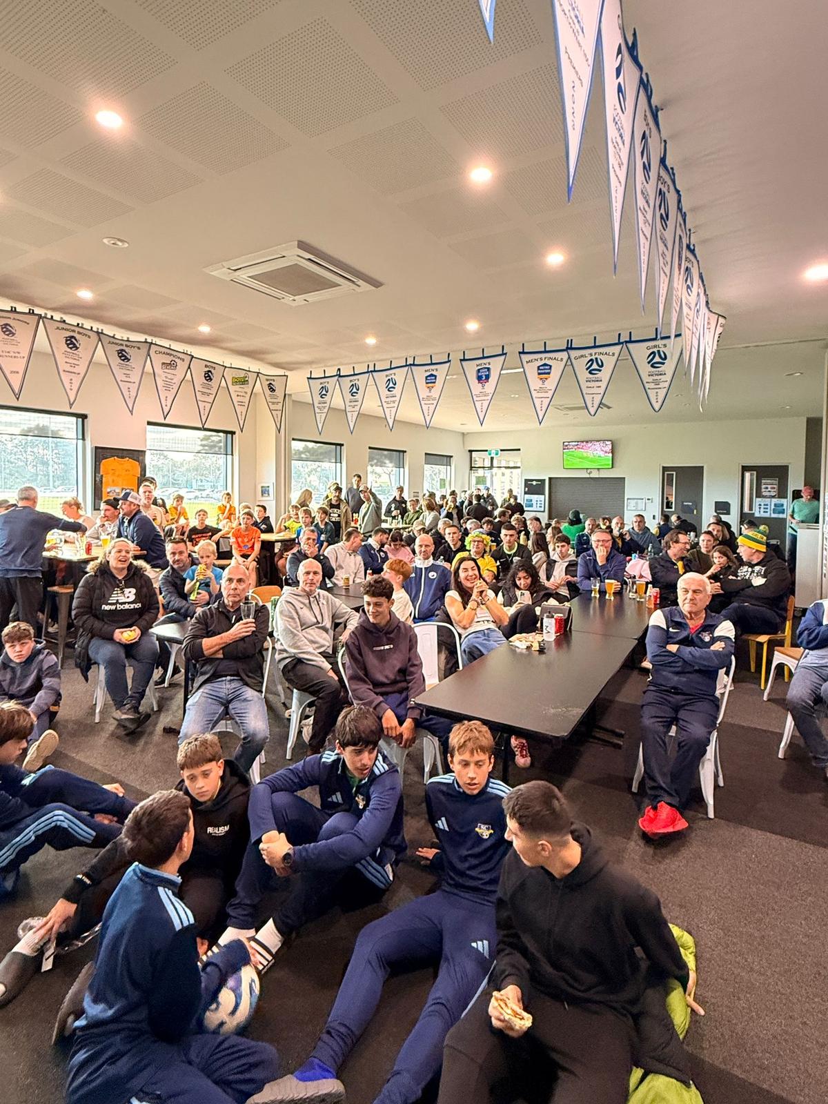 JT Gray clubrooms full of people watching the FIFA World Cup