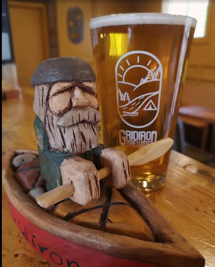Wooden figurine with a Gridiron beer