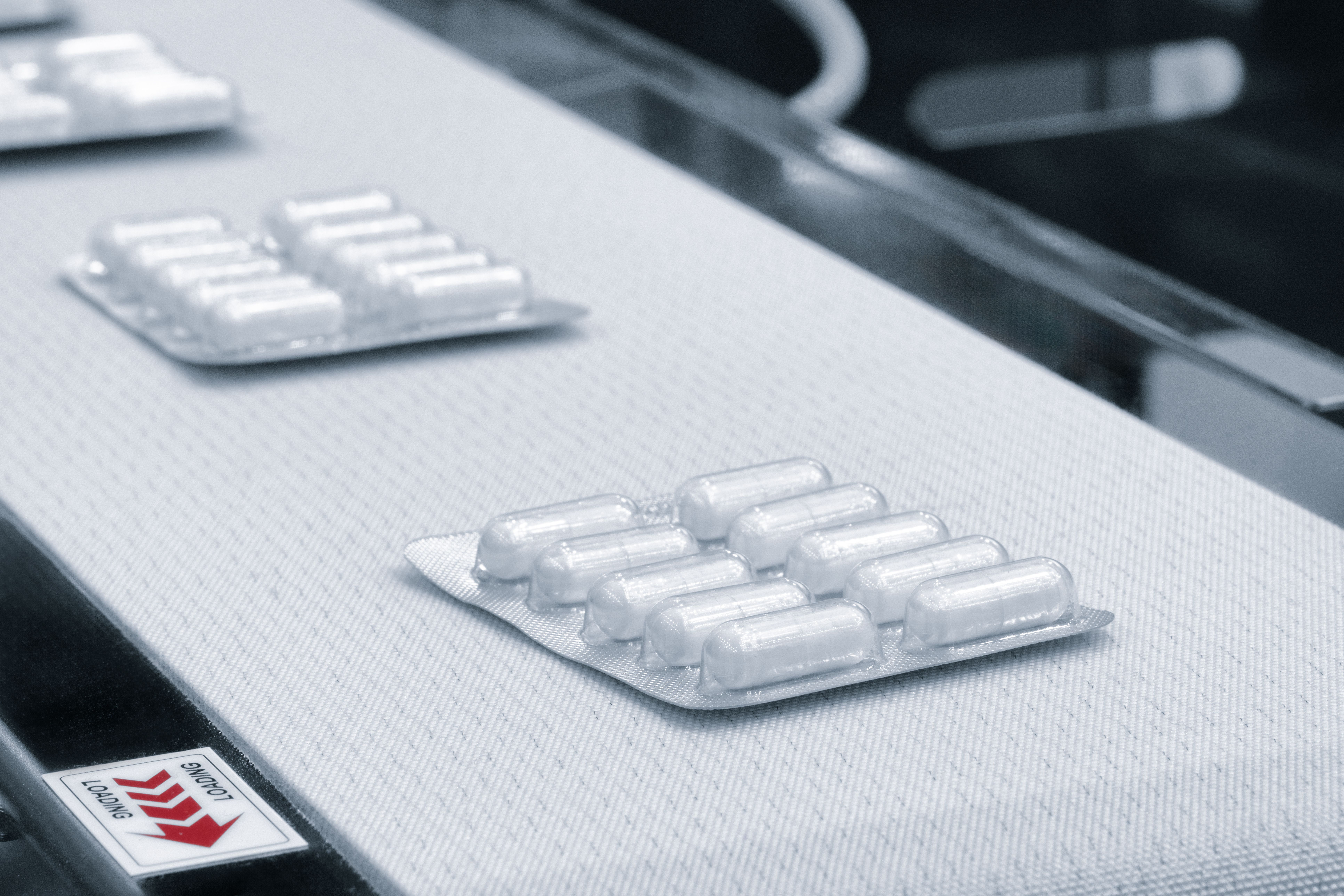 Blister-packed medicine moving along a pharmaceutical production line