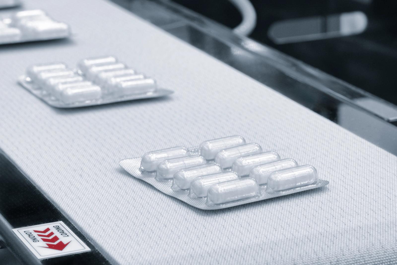 Blister-packed medicine moving along a pharmaceutical production line