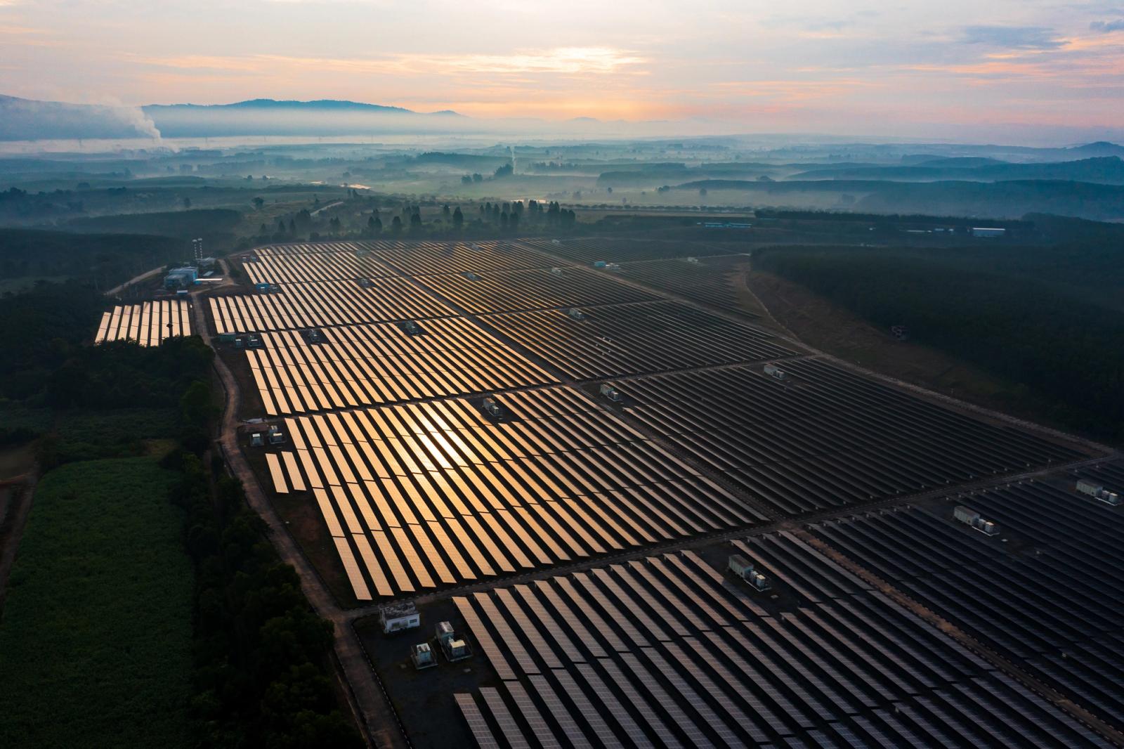 Aerial view of a large solar farm at sunrise