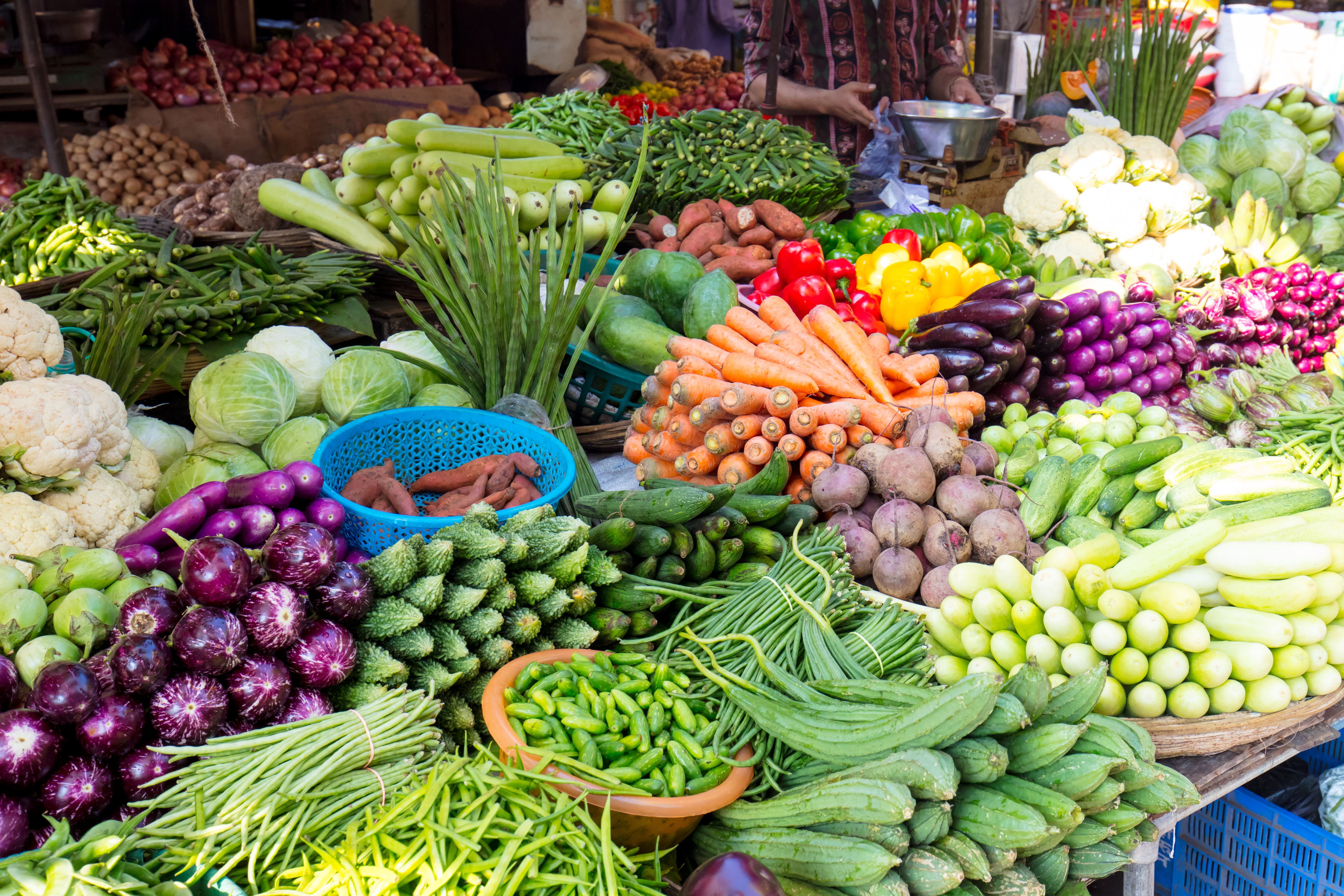 A market food stall in Mumbai laid out with abundant fresh fruit and vegetables