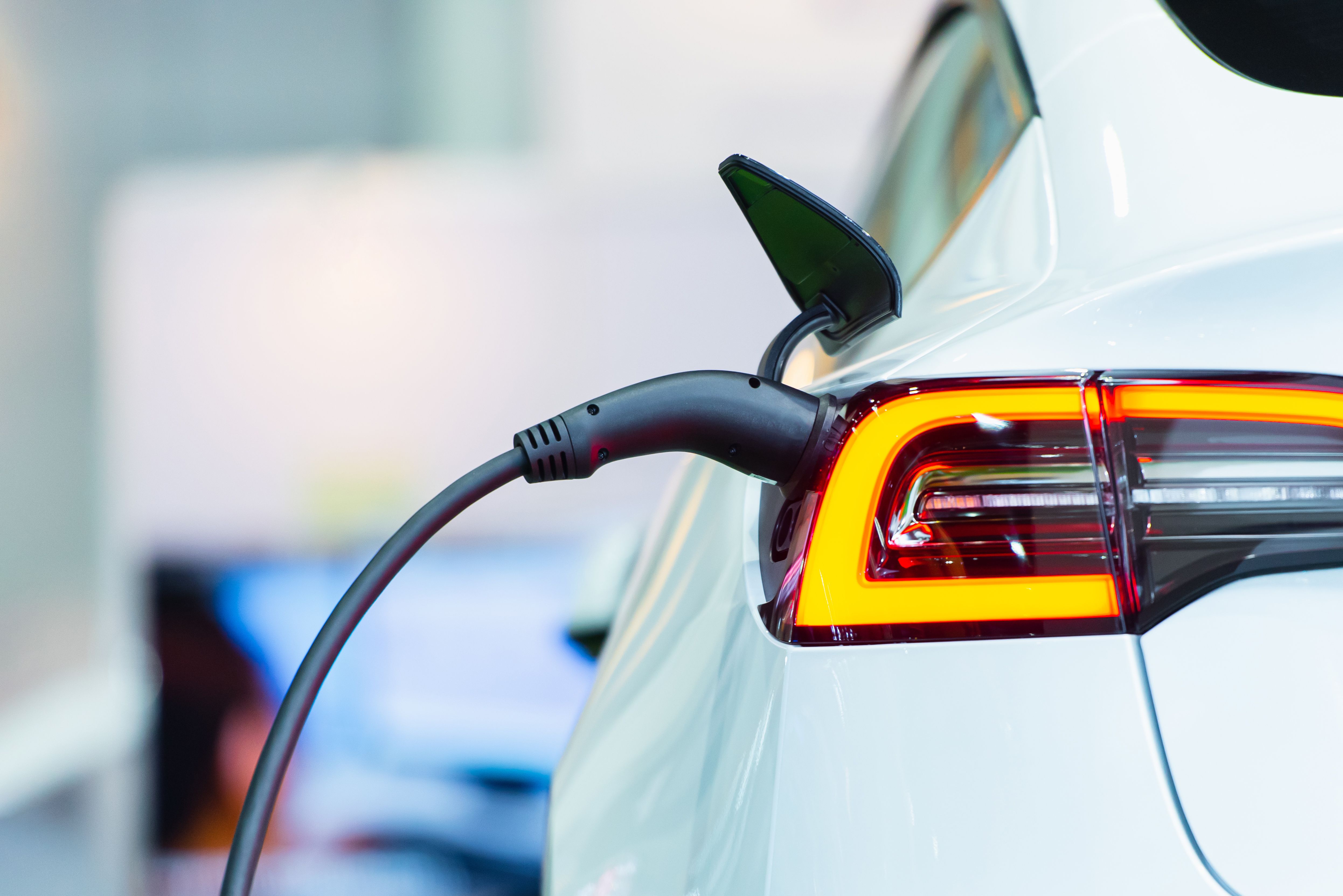 An electric car charging at a charging station
