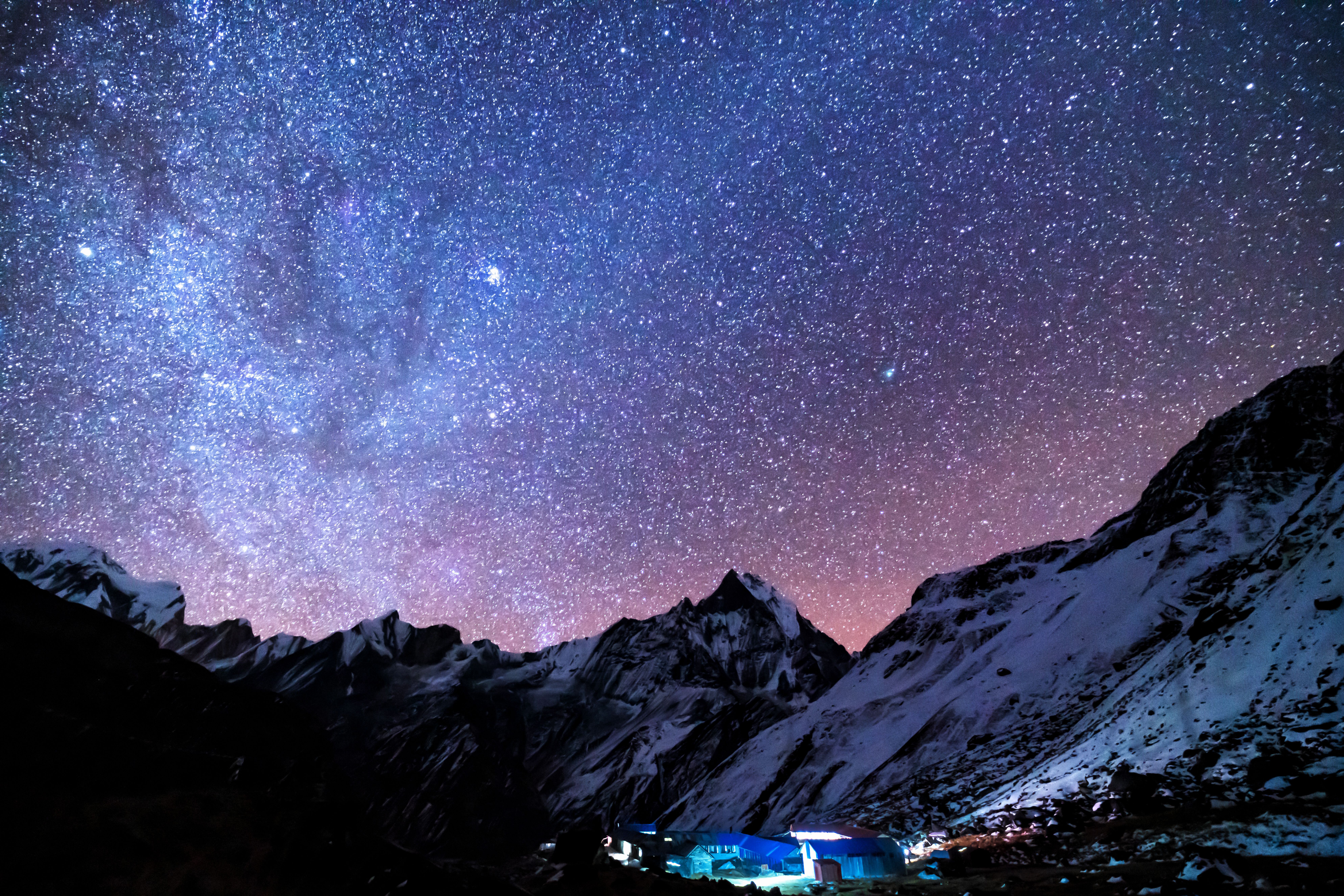The Milky Way arcing over a dark mountain landscape at night