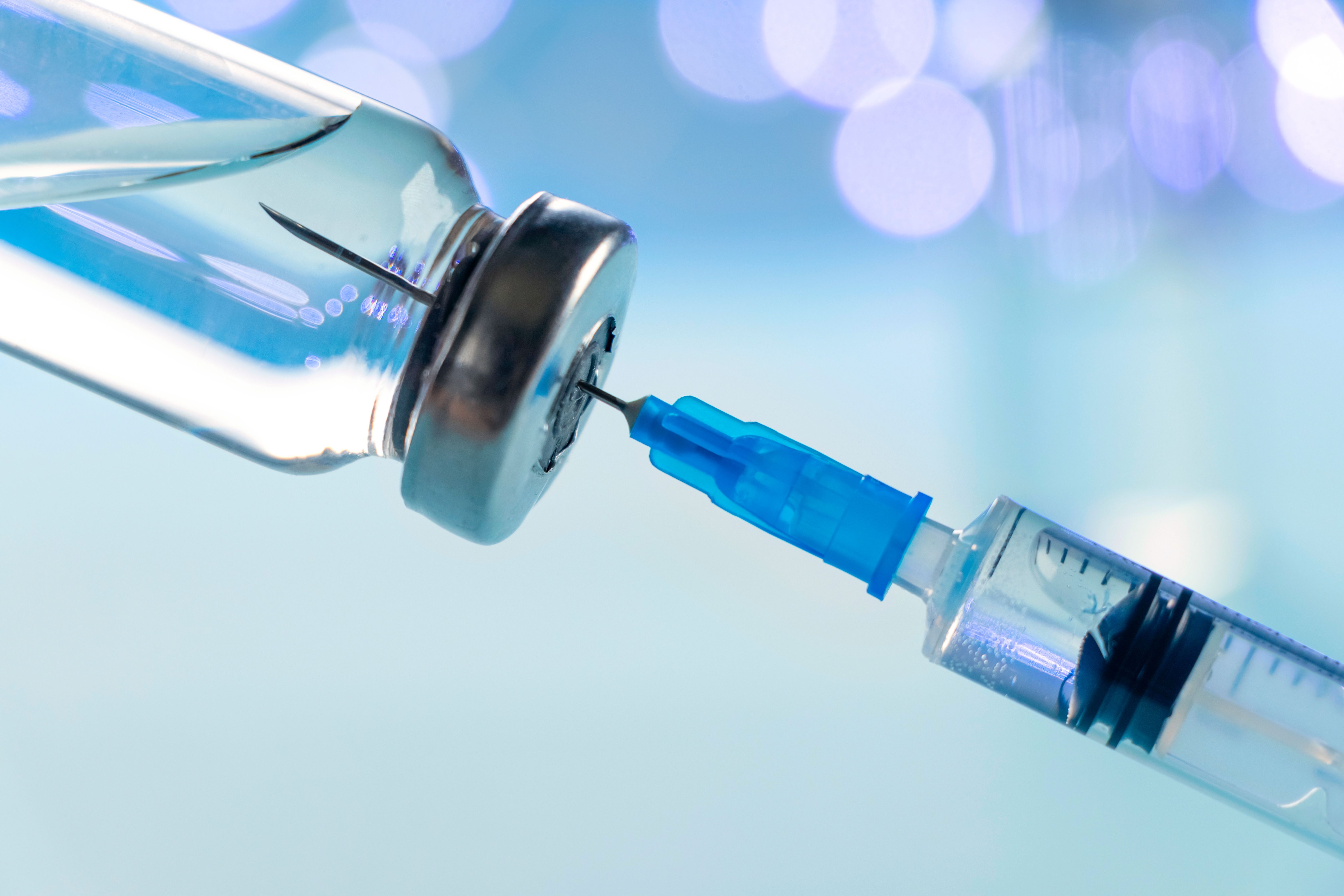 A vaccine vial and a syringe