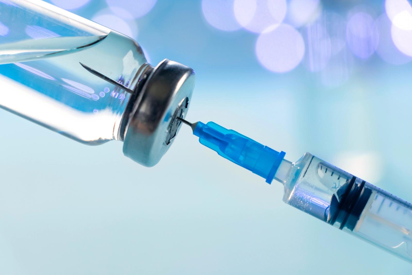 A vaccine vial and a syringe