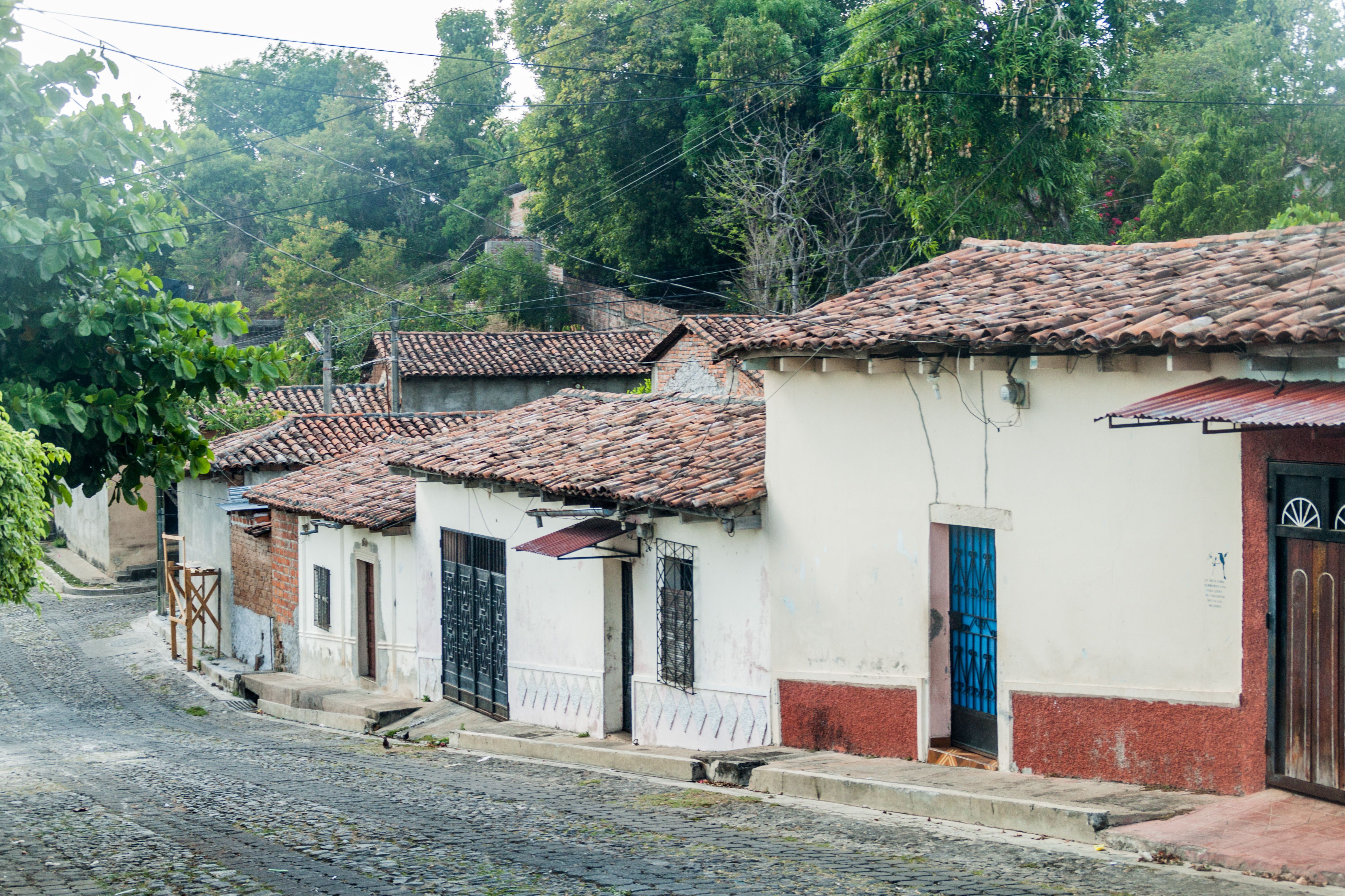 A cobbled street of low tile-roofed houses in Suchitoto, El Salvador