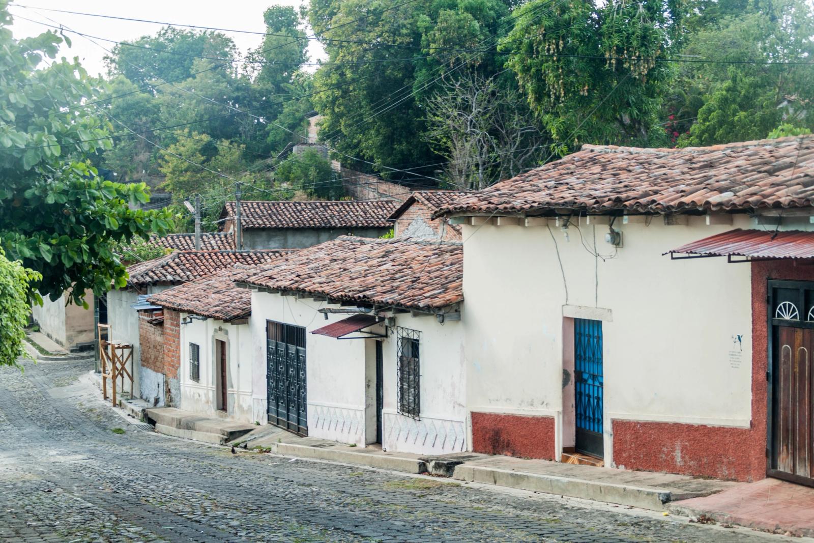 A cobbled street of low tile-roofed houses in Suchitoto, El Salvador