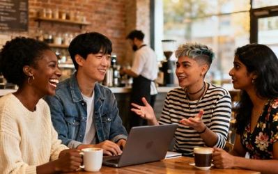 People naturally connecting at a local coffee shop, engaging in genuine conversation