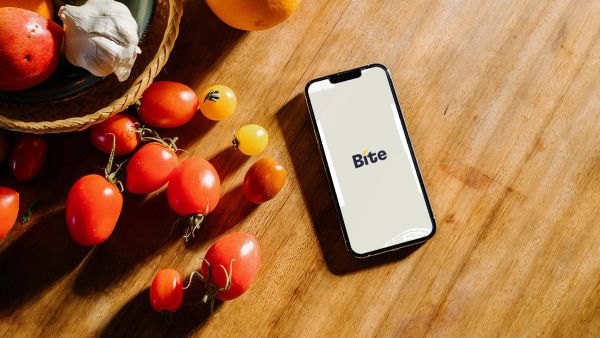 Bite logo in phone on cutting board